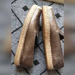 Stuart Weitzman shoes with hardware at rear with a metallic look.